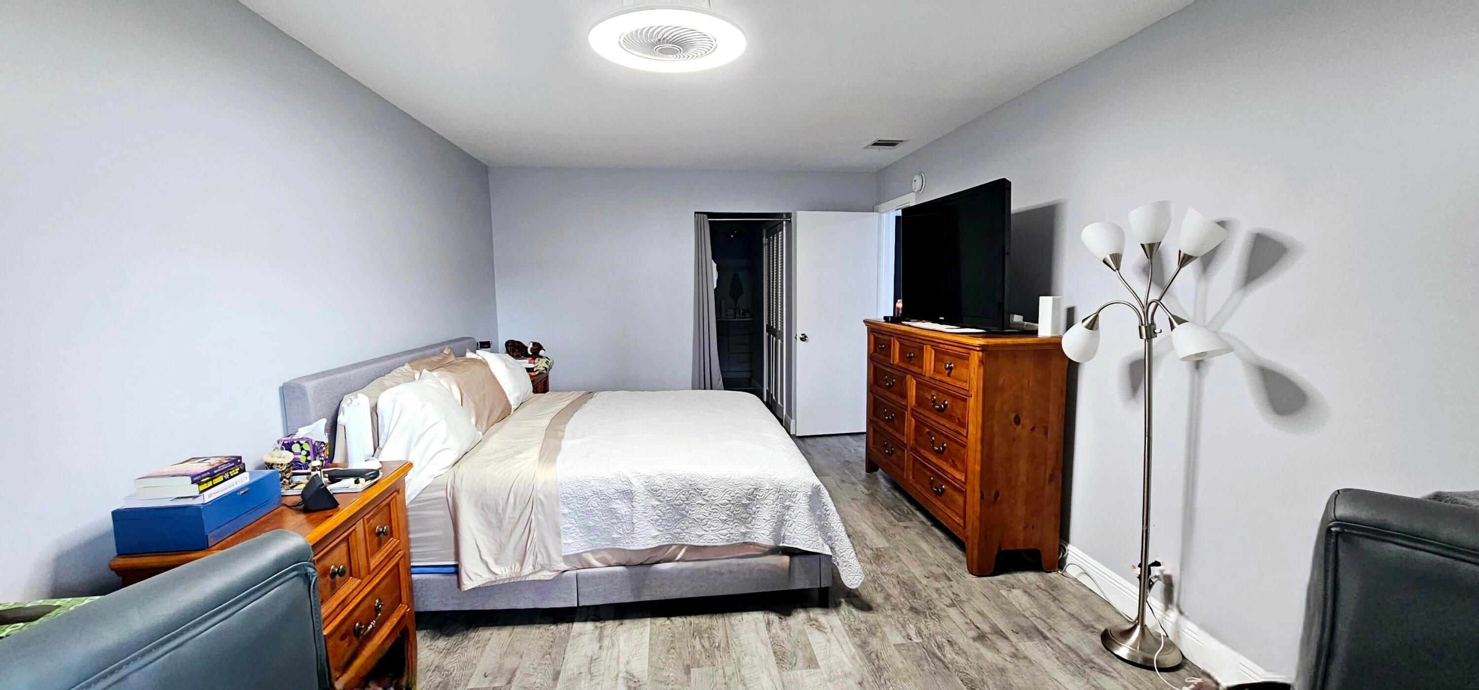 10126 South 44th Terrace Boynton Beach, FL 33436 - Photo 14 of 30 a bedroom with bed and wooden floor