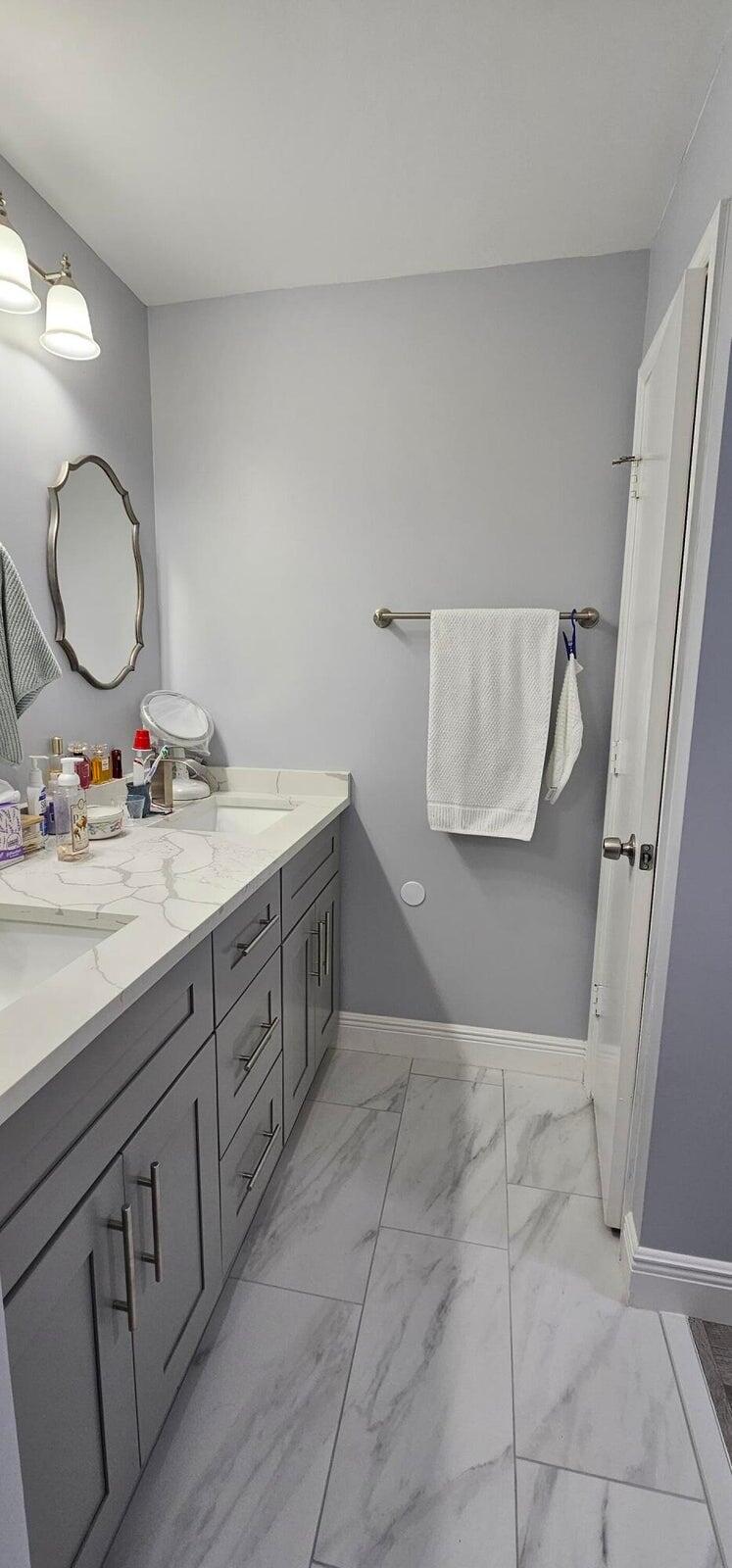 10126 South 44th Terrace Boynton Beach, FL 33436 - Photo 17 of 30 a bathroom with a double vanity sink and a mirror