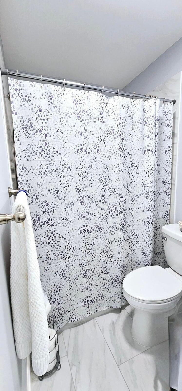 10126 South 44th Terrace Boynton Beach, FL 33436 - Photo 18 of 30 a bathroom with a toilet and a shower curtain