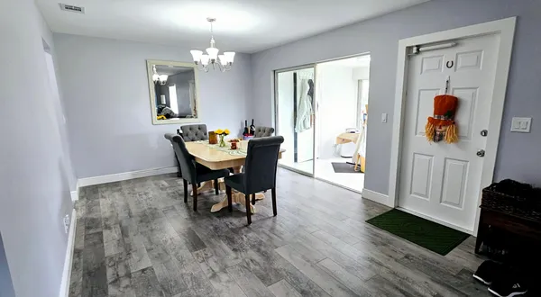a view of a dining room with furniture and wooden floor