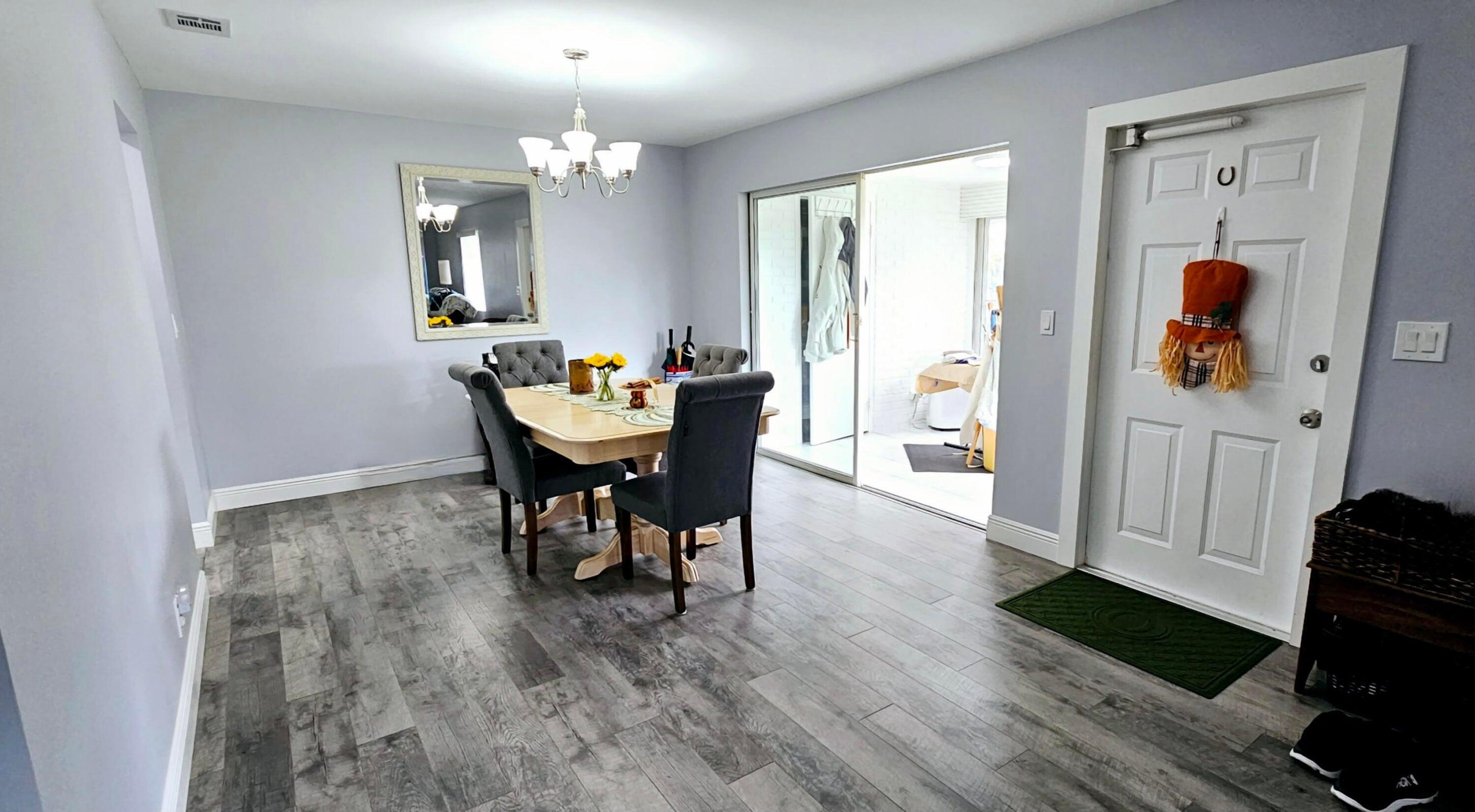 10126 South 44th Terrace Boynton Beach, FL 33436 - Photo 2 of 30 a view of a dining room with furniture and wooden floor