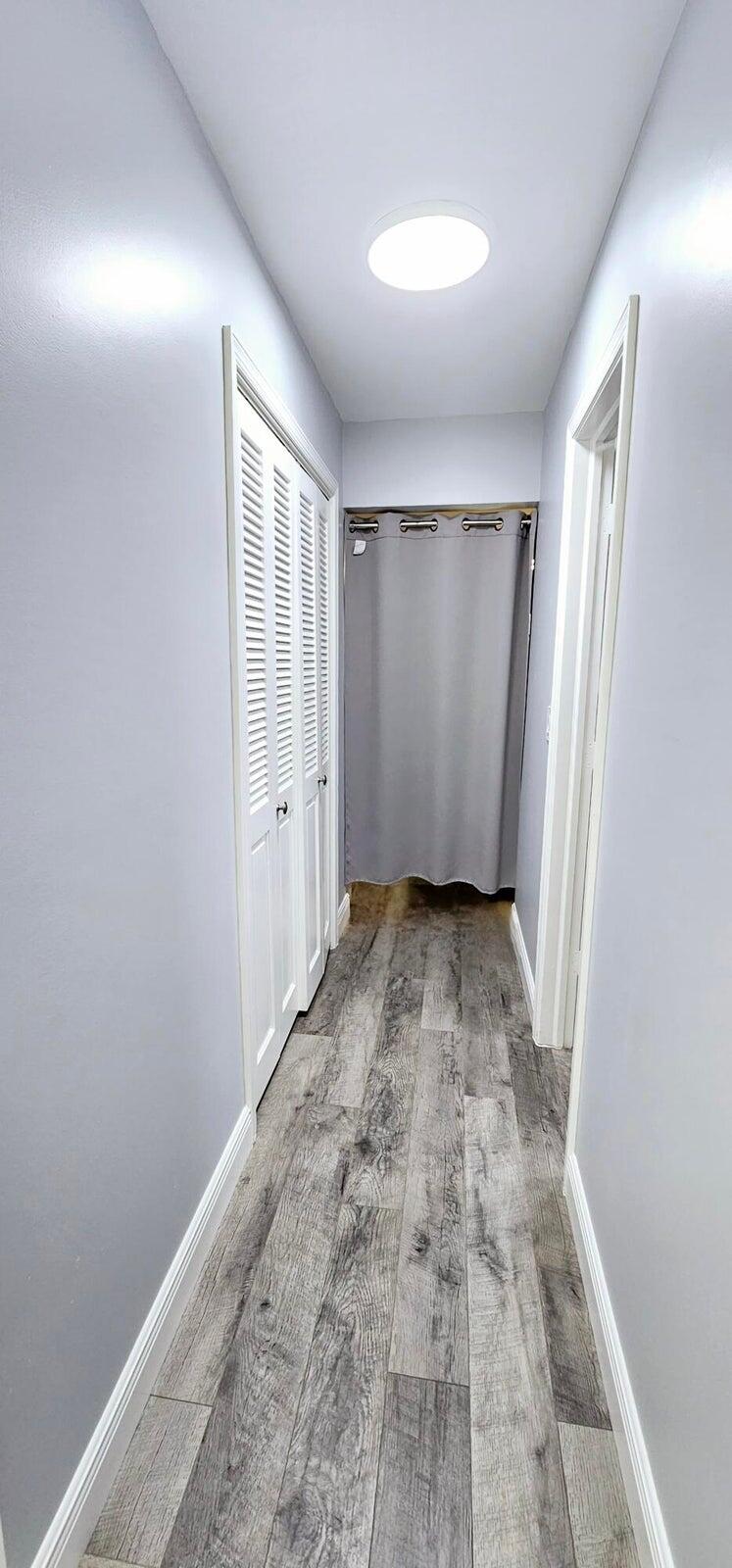 10126 South 44th Terrace Boynton Beach, FL 33436 - Photo 21 of 30 an empty room with wooden floor and windows