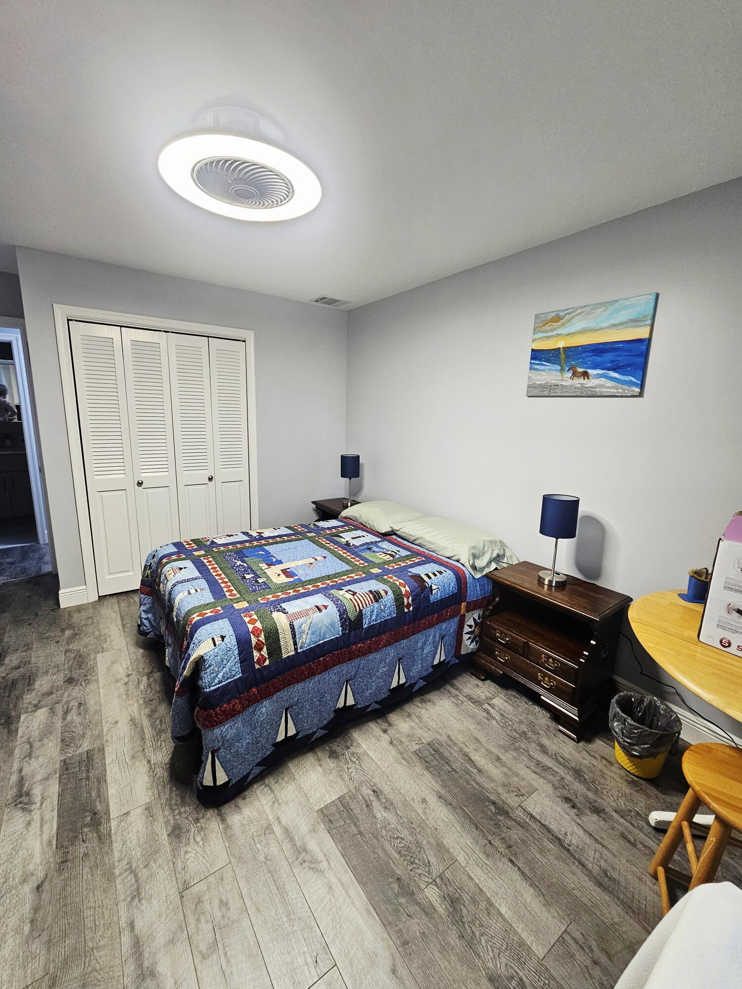 10126 South 44th Terrace Boynton Beach, FL 33436 - Photo 22 of 30 a bedroom with a bed and a chandelier