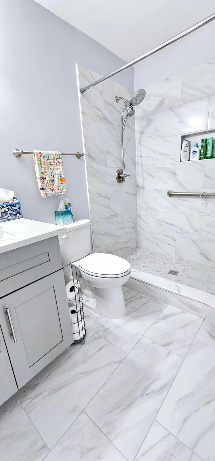 10126 South 44th Terrace Boynton Beach, FL 33436 - Photo 24 of 30 a bathroom with a sink a toilet and shower