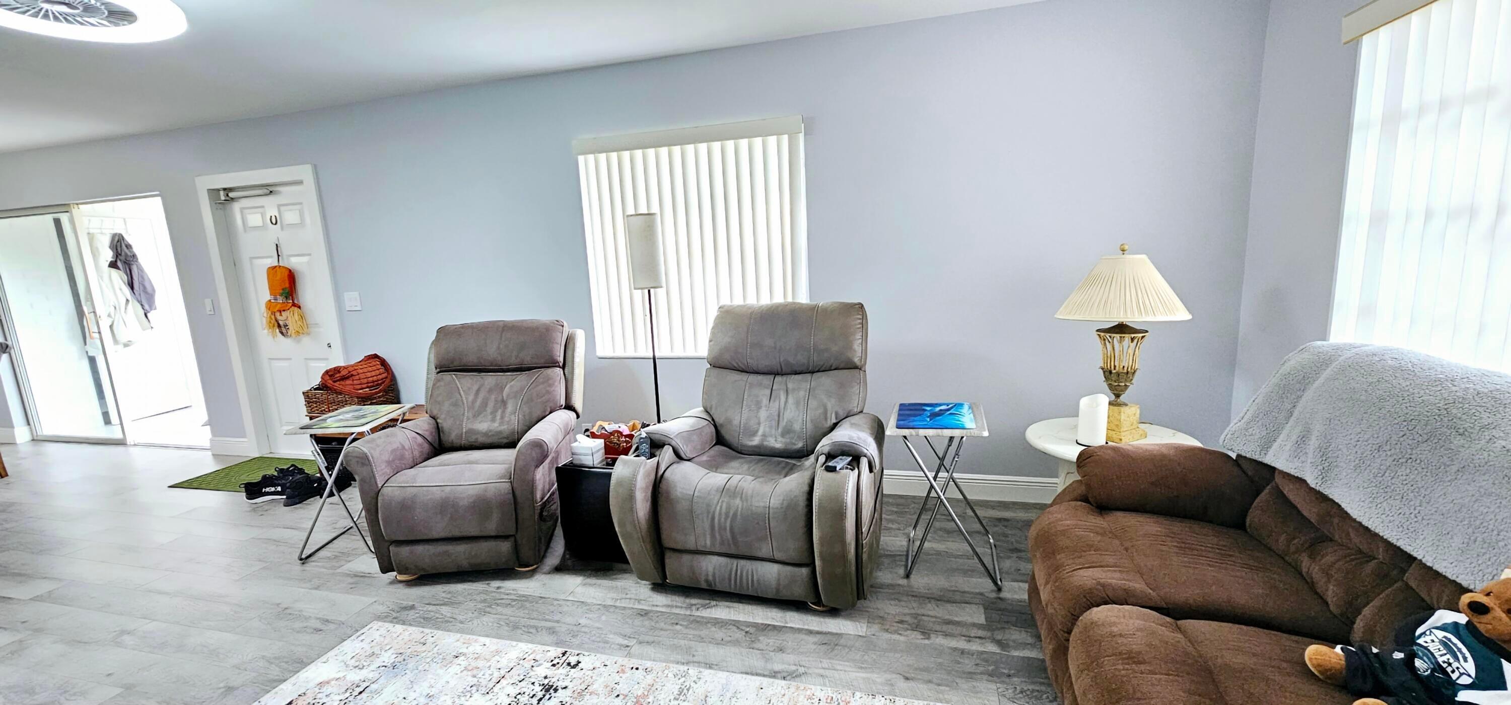 10126 South 44th Terrace Boynton Beach, FL 33436 - Photo 4 of 30 a living room with furniture a window and a lamp