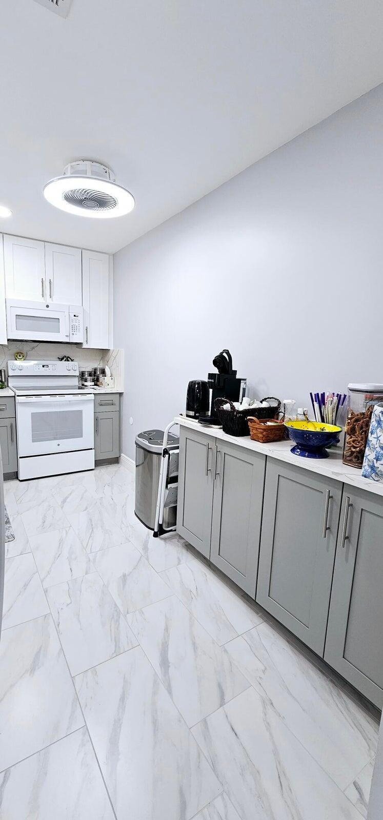 10126 South 44th Terrace Boynton Beach, FL 33436 - Photo 10 of 30 a kitchen with stainless steel appliances a sink and cabinets