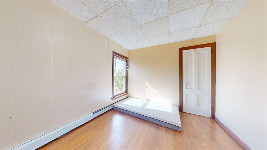 1022 Main Street Worcester, MA 01603 - Photo 11 of 40 an empty room with wooden floor and windows