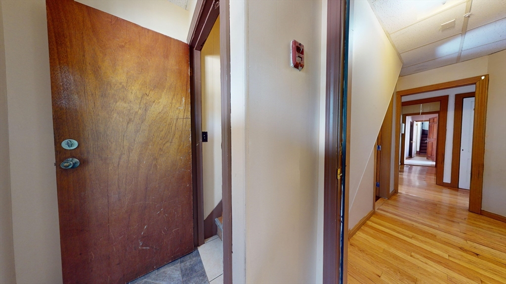 1022 Main Street Worcester, MA 01603 - Photo 14 of 40 a view of a hallway with wooden floor and staircase