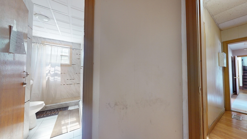 1022 Main Street Worcester, MA 01603 - Photo 17 of 40 a bathroom with a glass shower door