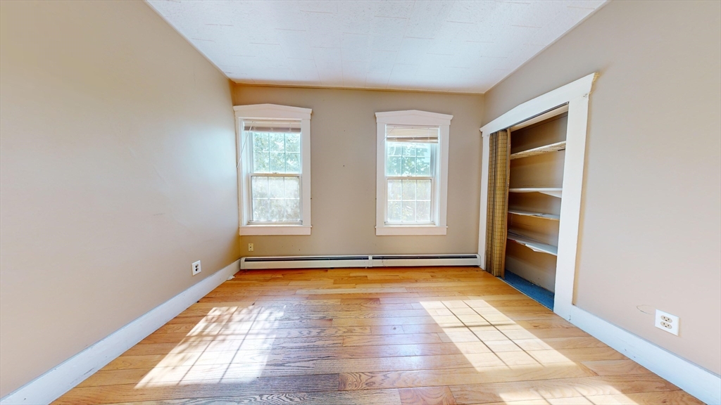 1022 Main Street Worcester, MA 01603 - Photo 18 of 40 a view of an empty room with a window and wooden floor