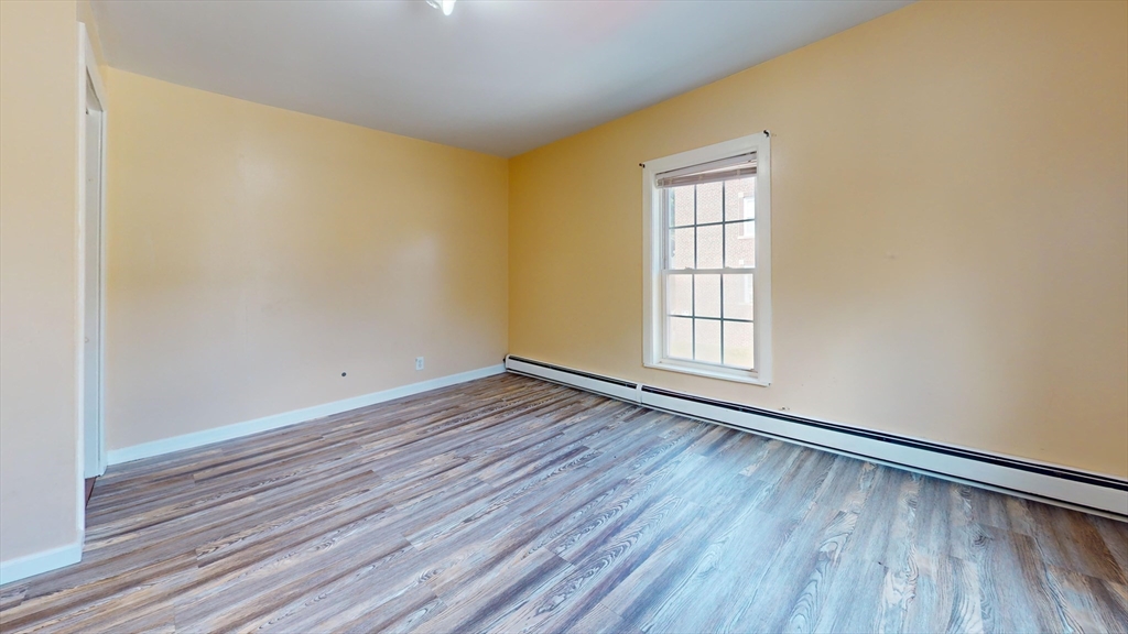 1022 Main Street Worcester, MA 01603 - Photo 21 of 40 an empty room with wooden floor and windows