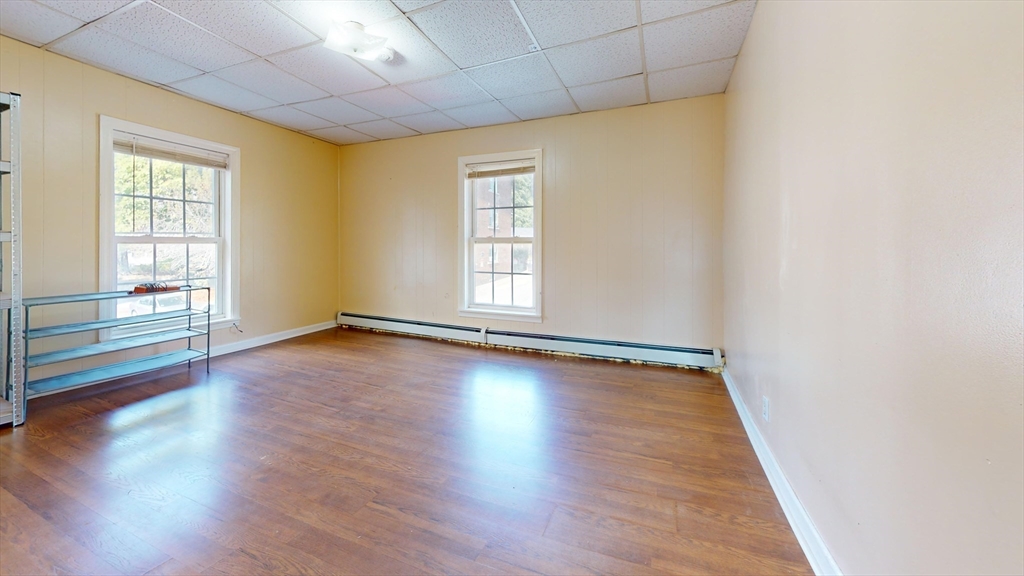 1022 Main Street Worcester, MA 01603 - Photo 27 of 40 an empty room with wooden floor and windows