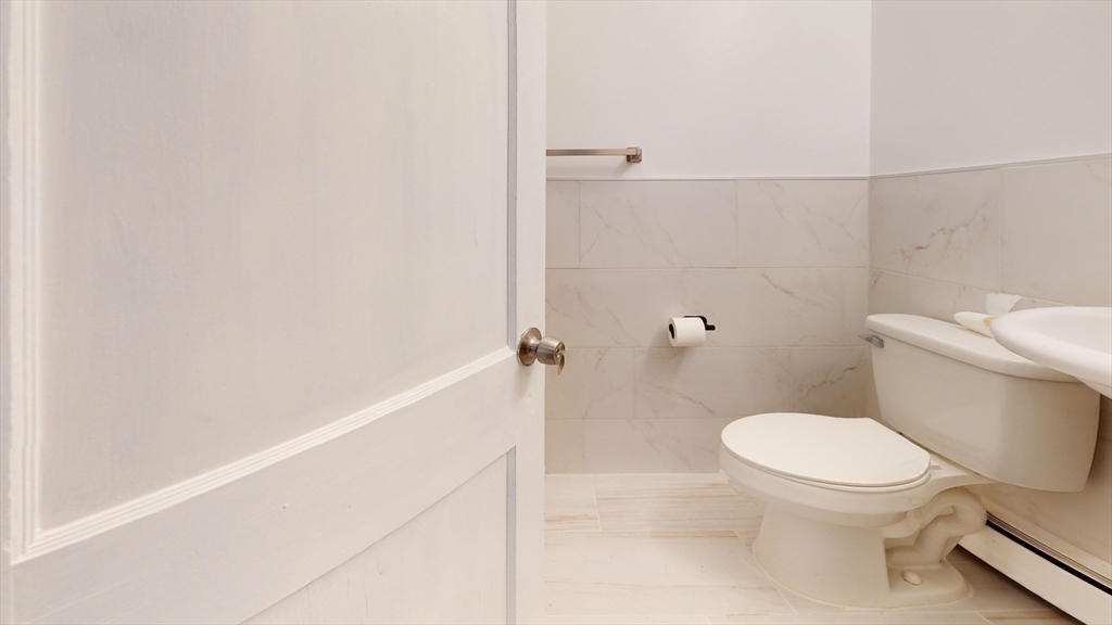 1022 Main Street Worcester, MA 01603 - Photo 3 of 40 a white toilet sitting next to a shower