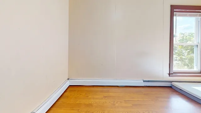 a view of a room with an empty space and a window