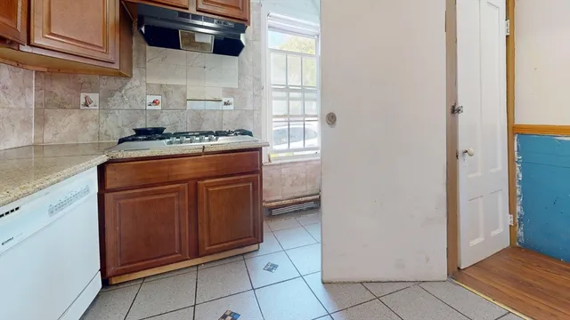 a kitchen with stainless steel appliances granite countertop a stove and a refrigerator