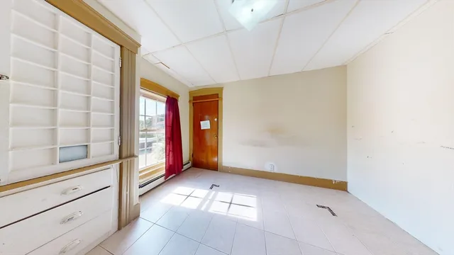 a view of a room with window and hardwood floor