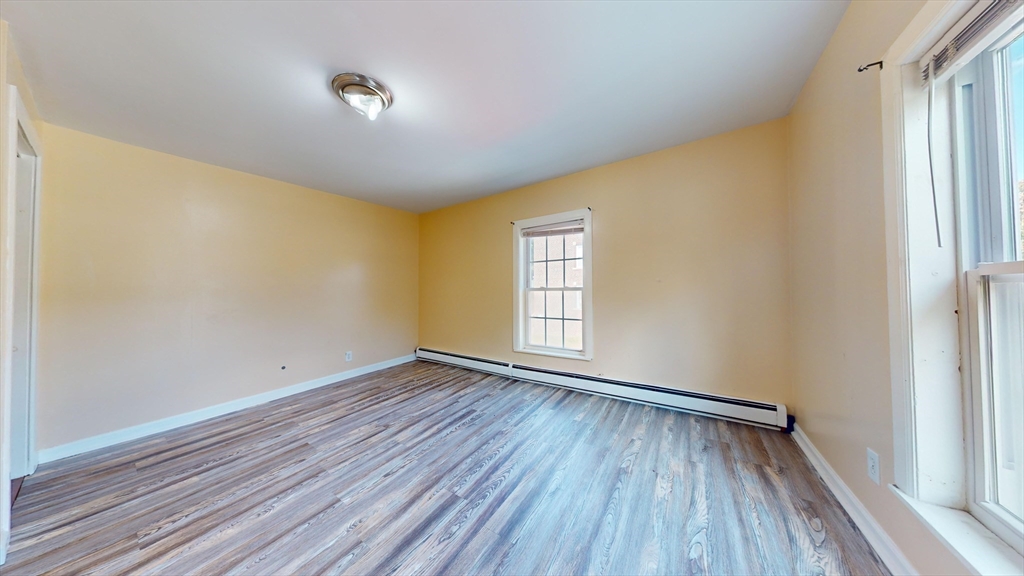 1022 Main Street Worcester, MA 01603 - Photo 10 of 40 a view of an empty room with wooden floor and a window