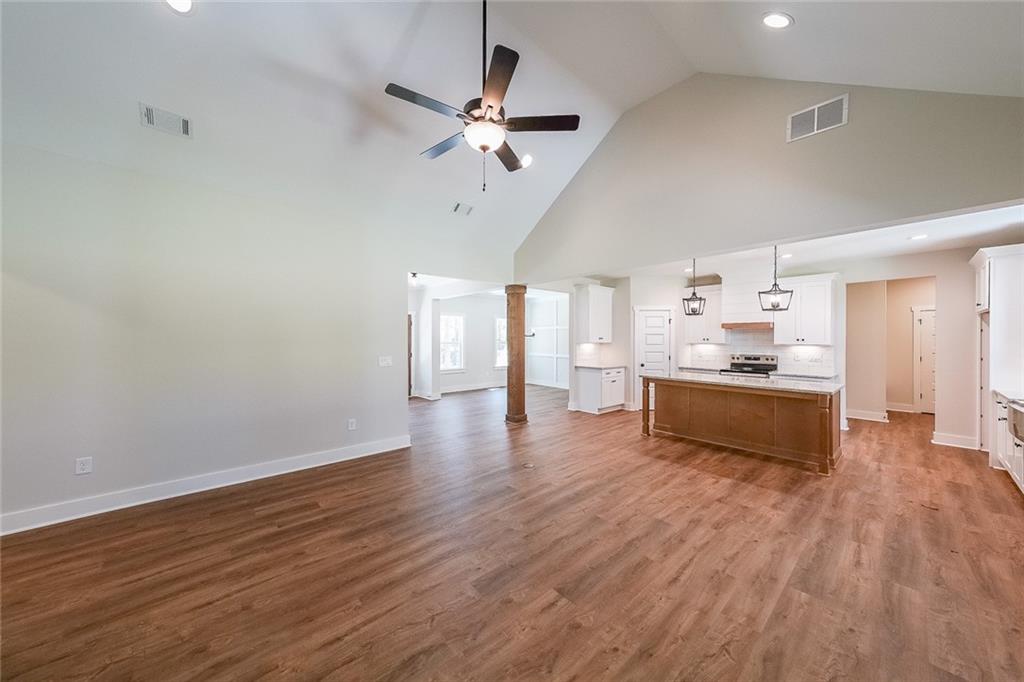3300 Holly Springs Road Rockmart, GA 30153 - Photo 16 of 38 a large kitchen with cabinets wooden floor and stainless steel appliances