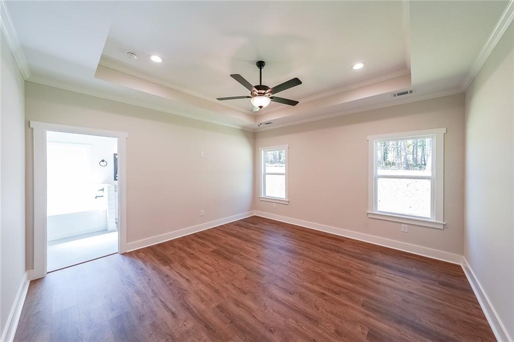 3300 Holly Springs Road Rockmart, GA 30153 - Photo 19 of 38 an empty room with wooden floor and windows