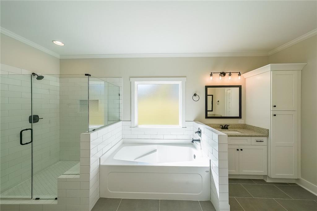 3300 Holly Springs Road Rockmart, GA 30153 - Photo 21 of 38 a spacious bathroom with a tub sink shower and mirror