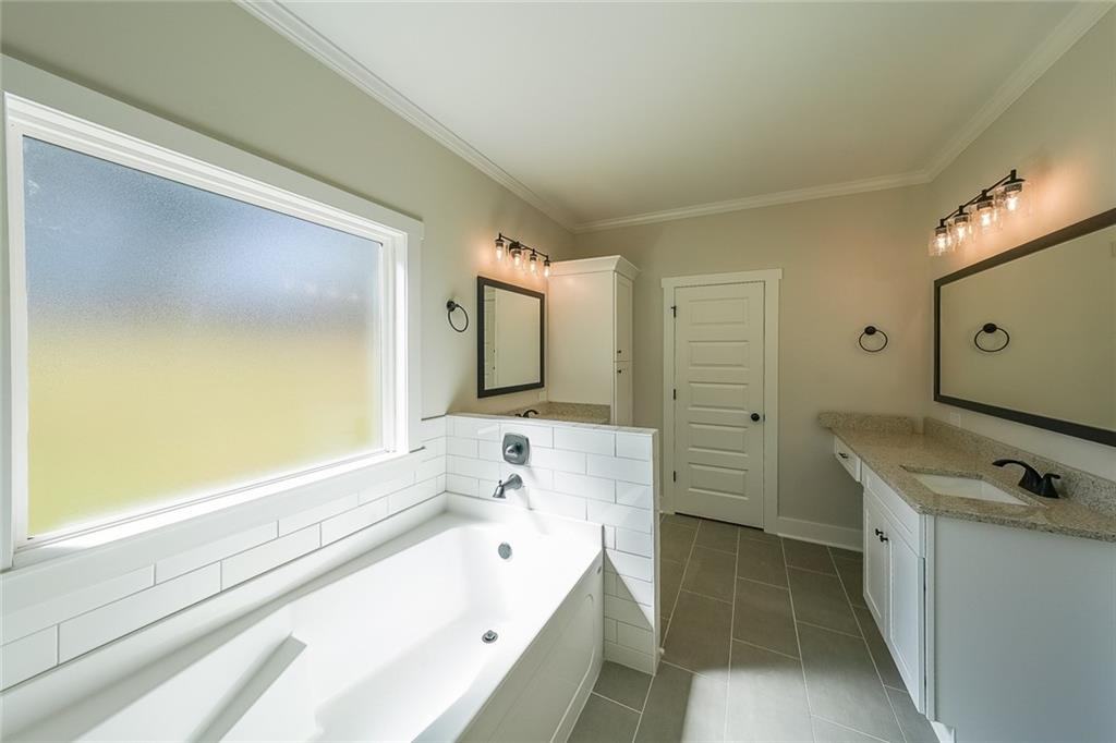 3300 Holly Springs Road Rockmart, GA 30153 - Photo 23 of 38 a bathroom with a bathtub sink and mirror