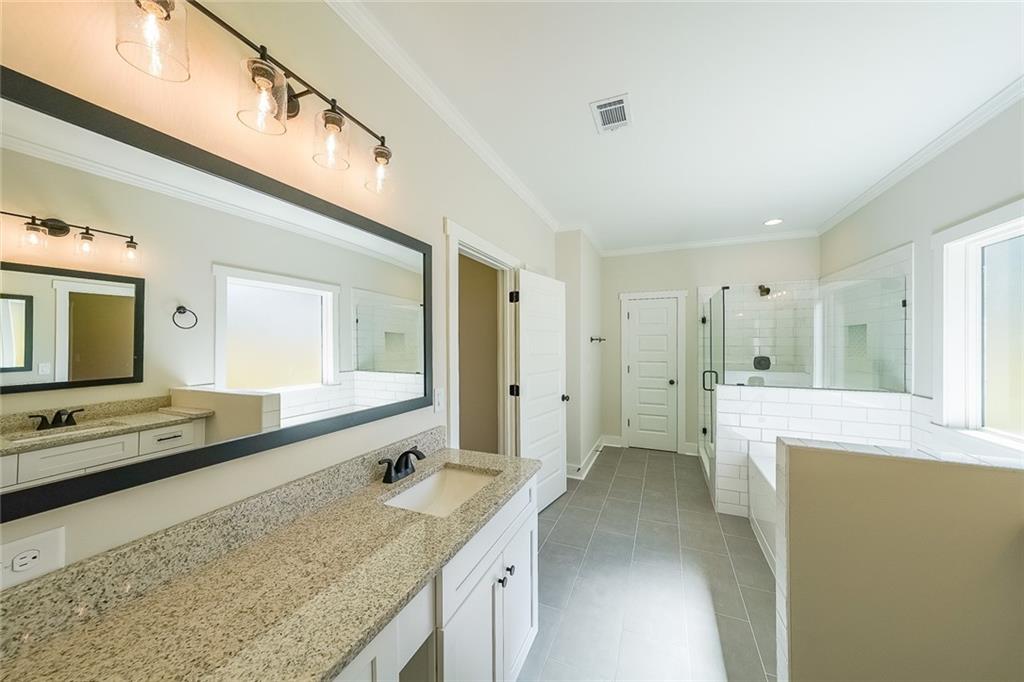 3300 Holly Springs Road Rockmart, GA 30153 - Photo 26 of 38 a bathroom with a granite countertop double vanity sink and mirror
