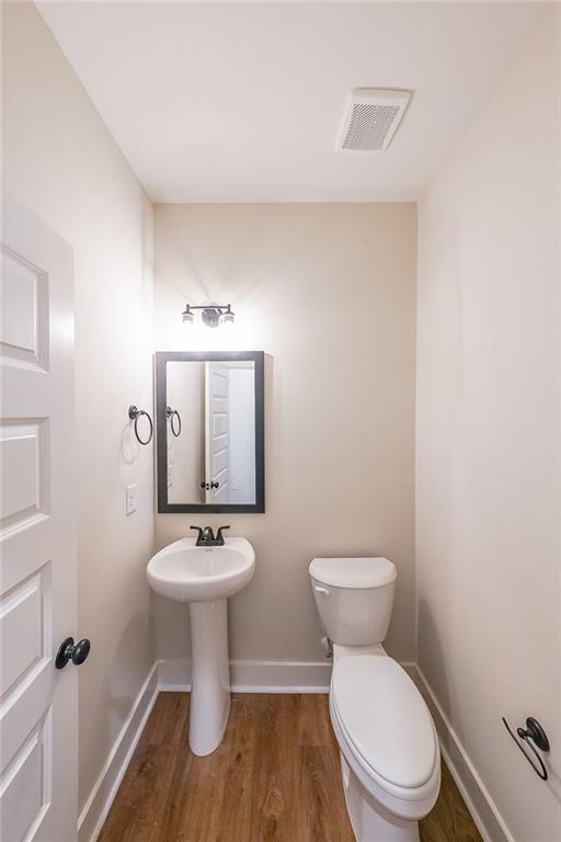 3300 Holly Springs Road Rockmart, GA 30153 - Photo 28 of 38 a bathroom with a toilet sink and mirror