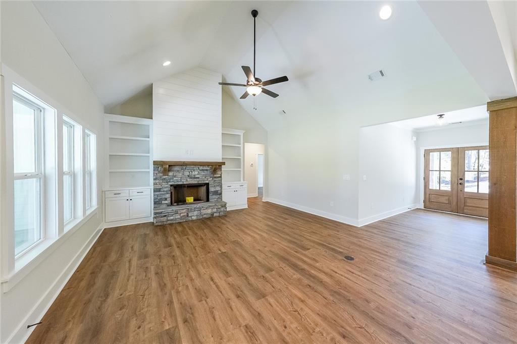 3300 Holly Springs Road Rockmart, GA 30153 - Photo 6 of 38 a view of empty room with wooden floor and fireplace