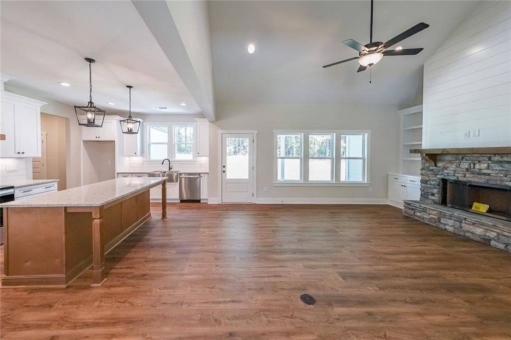 3300 Holly Springs Road Rockmart, GA 30153 - Photo 9 of 38 a large kitchen with cabinets a sink and a fireplace