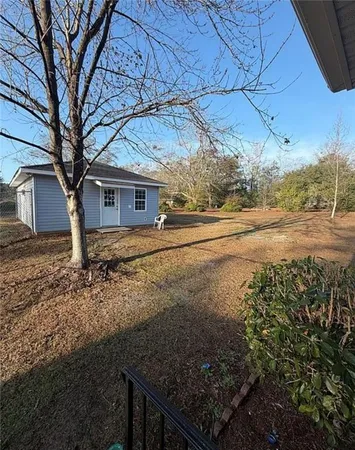 a view of a backyard with large trees