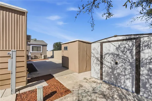 a view of a porch with a floor to ceiling window and tree
