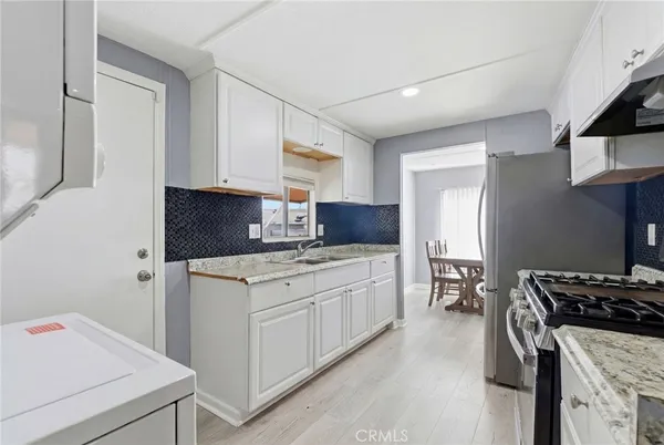 a kitchen with a stove and a refrigerator