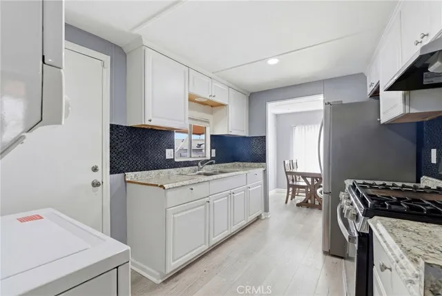 a kitchen with a stove and a refrigerator