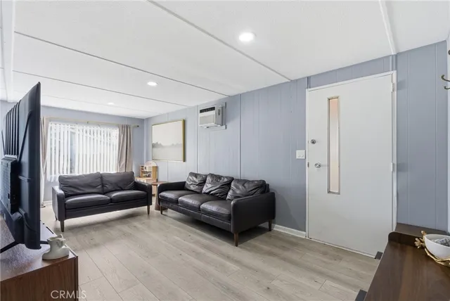 a living room with furniture window and a flat screen tv