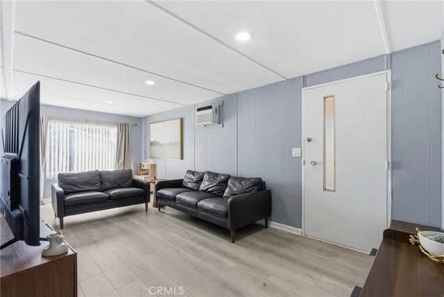 a living room with furniture window and a flat screen tv