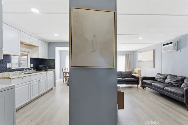 a kitchen with a refrigerator and a stove top oven