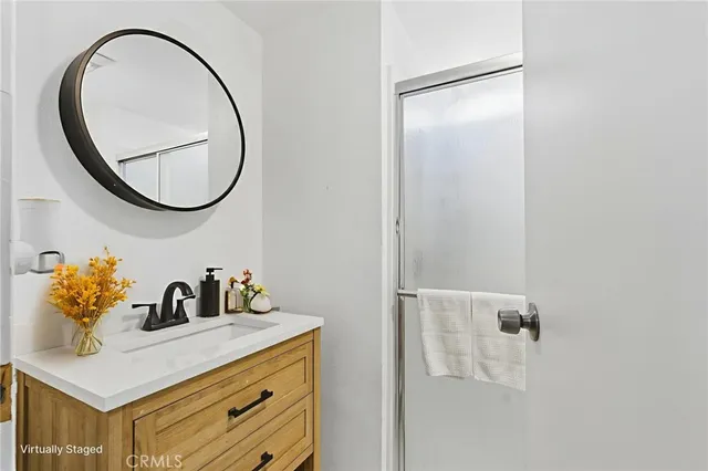 a bathroom with a sink vanity and a mirror