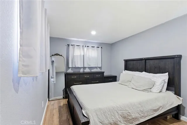 a bedroom with a bed and a large mirror