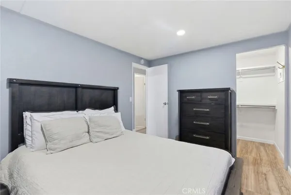 a bedroom with a bed and a dresser