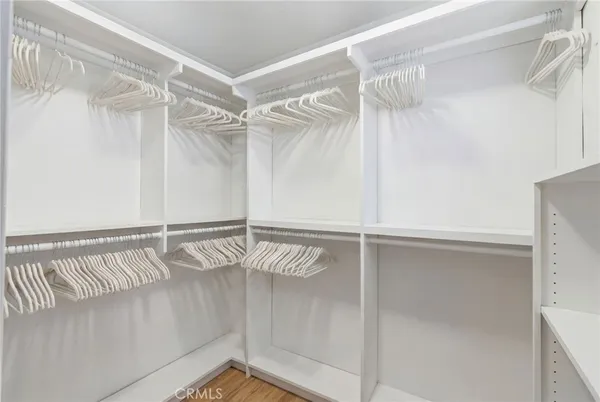 a view of walk in closet with empty racks