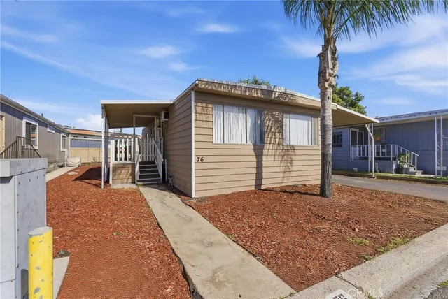 a view of a house with a backyard