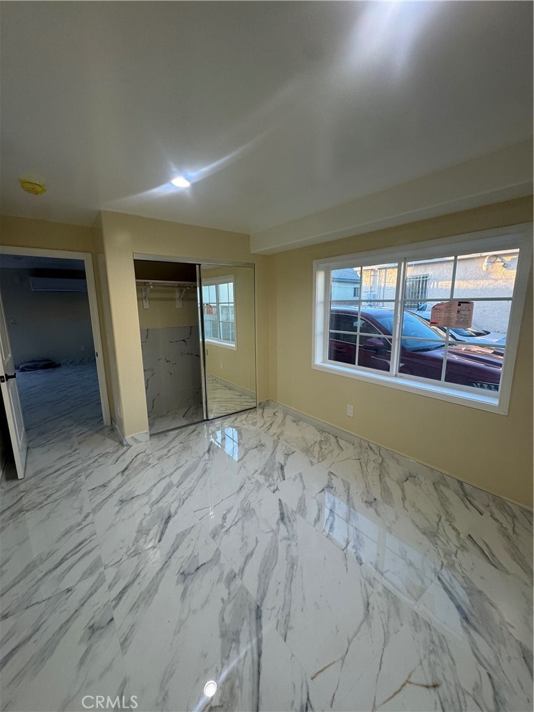 3528 West 109th Street, Unit 1/2 Inglewood, CA 90303 - Photo 5 of 6 a view of an empty room with wooden floor and fan