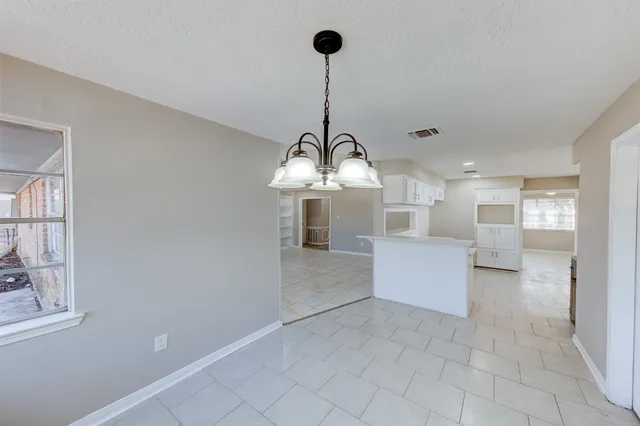 a view of a kitchen with furniture and cabinets