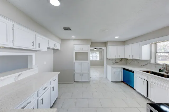 a kitchen with a sink cabinets and window