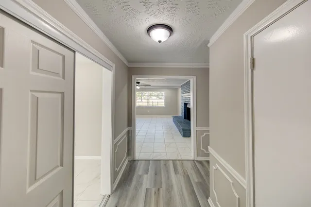 a view of a hallway view with wooden floor and staircase