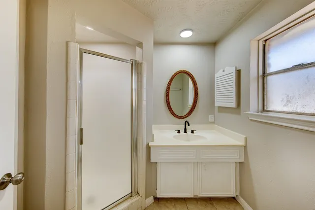 a bathroom with a sink mirror and a window
