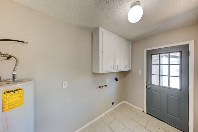 a view of storage and utility room with a window