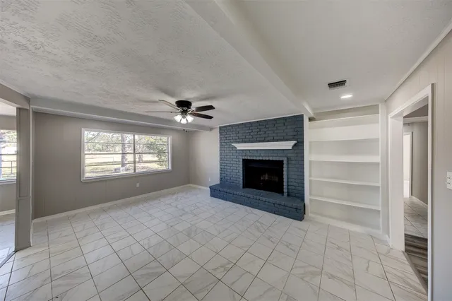 a view of empty room with a fireplace