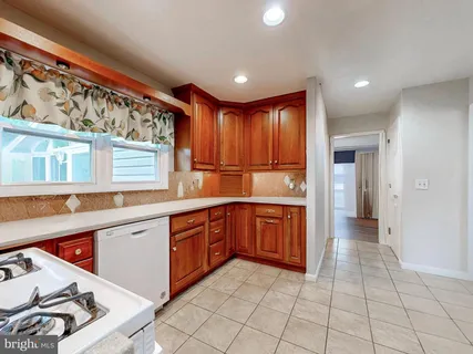 a view of a kitchen with a sink and cabinets