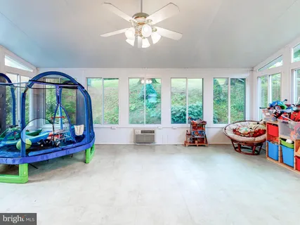 a view of room with window and ceiling fan